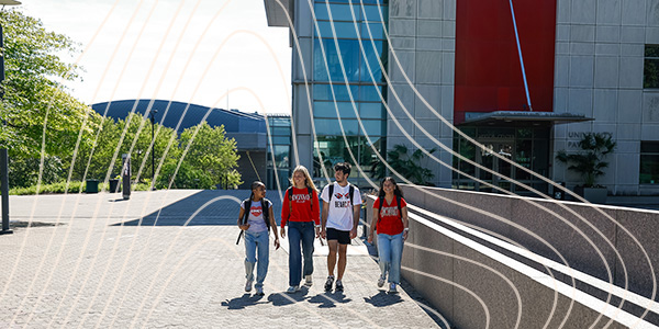 four students walking on campus
